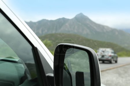 Photo for Beautiful view of car on asphalt highway in mountains, closeup. Road trip - Royalty Free Image
