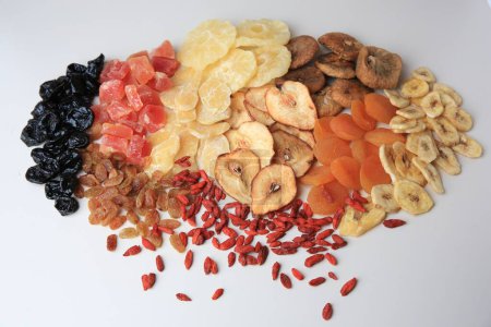 Different tasty dried fruits on white background, top view
