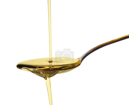 Pouring cooking oil into spoon on white background