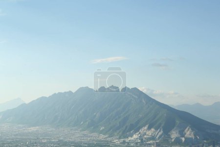 Photo for Big mountains and city under blue sky on sunny day - Royalty Free Image