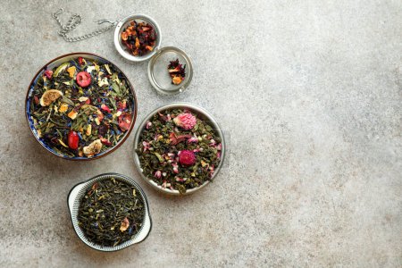 Many different herbal teas on grey table, flat lay. Space for text