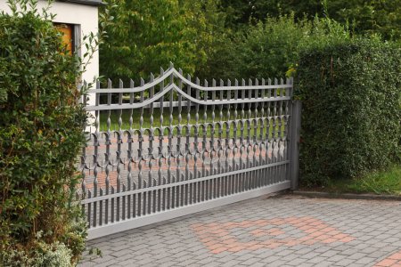 Photo for Grey metal gates near private house on street - Royalty Free Image