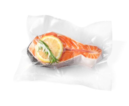 Salmon with lemon in vacuum pack on white background, top view
