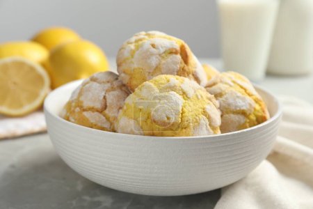 Delicious lemon cookies in bowl on grey table, closeup