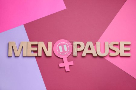 Photo for Word Menopause made of wooden letters and female gender sign on color background flat lay - Royalty Free Image