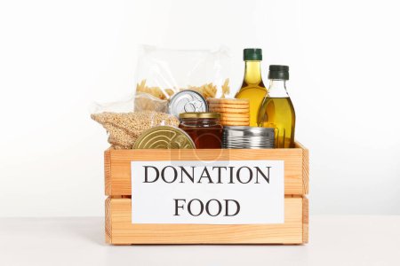 Photo for Donation crate with food isolated on white - Royalty Free Image