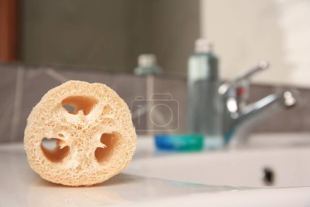 Photo for Loofah sponge on sink in bathroom, closeup. Space for text - Royalty Free Image