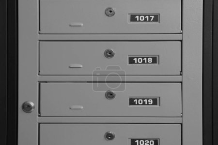 Photo for Closed metal mailboxes with keyholes and sequence numbers indoors - Royalty Free Image
