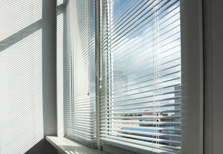 Photo for Stylish window with horizontal blinds in room - Royalty Free Image