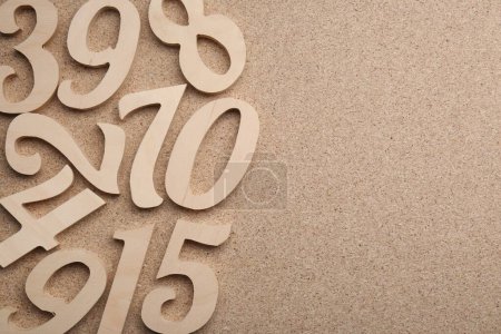 Photo for Wooden numbers on fiberboard, flat lay. Space for text - Royalty Free Image