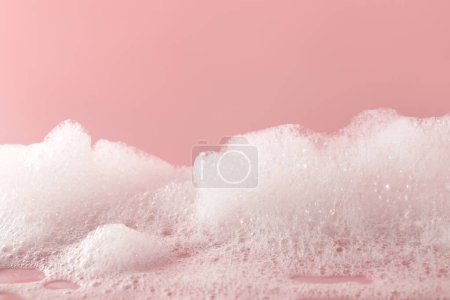 Photo for Fluffy bath foam on pink background, closeup - Royalty Free Image