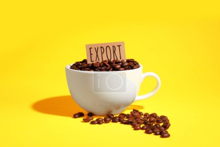 Photo for Coffee beans, white cup and card with word Export on yellow background - Royalty Free Image