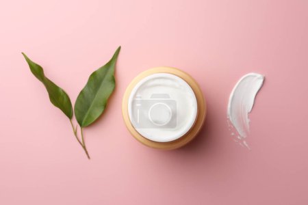 Photo for Jar of face cream, sample and fresh leaves on pink background, flat lay - Royalty Free Image