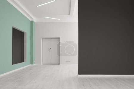 Photo for Empty room with green wall, opening for fake window and entrance during repair - Royalty Free Image