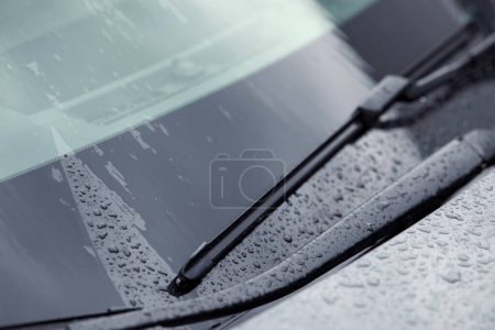Photo for Car wiper cleaning water drops from windshield glass, closeup - Royalty Free Image