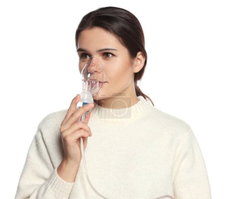 Photo for Young woman using nebulizer on white background - Royalty Free Image