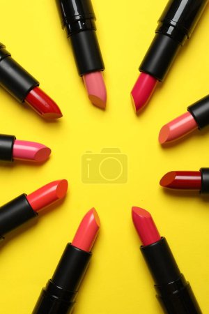 Frame of bright lipsticks on yellow background, flat lay. Space for text Poster 626139106
