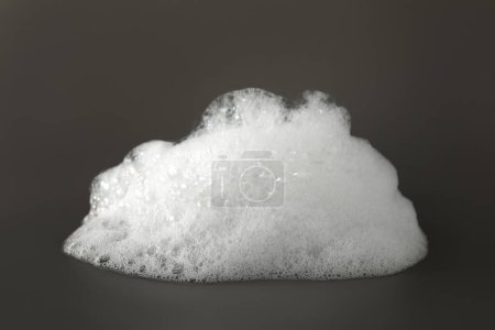 Photo for Fluffy bath foam on grey background, closeup - Royalty Free Image