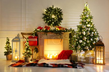 Photo for Beautiful Christmas themed photo zone with fireplace and fir decor - Royalty Free Image