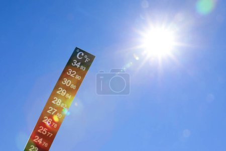 Photo for Weather thermometer against blue sky, space for text - Royalty Free Image