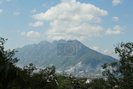 Photo for Picturesque view of mountains, city and trees under cloudy sky - Royalty Free Image