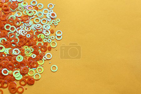 Photo for Shiny bright glitter on pale orange background. Space for text - Royalty Free Image