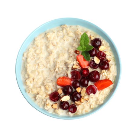 Bowl of oatmeal porridge with berries isolated on white, top view