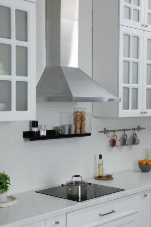 Photo for Elegant kitchen interior with range hood and furniture - Royalty Free Image