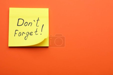 Photo for Paper note with phrase Don t Forget on orange background, top view. Space for text - Royalty Free Image