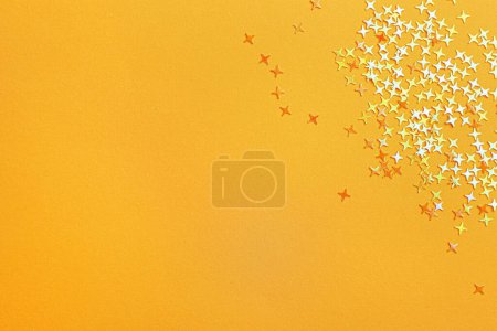 Photo for Shiny bright glitter on light orange background, flat lay. Space for text - Royalty Free Image