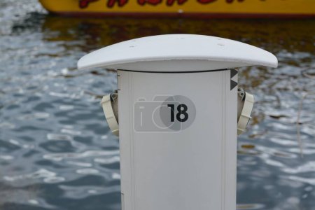 Photo for Charging station for boats with electrical outlets in harbor near sea - Royalty Free Image