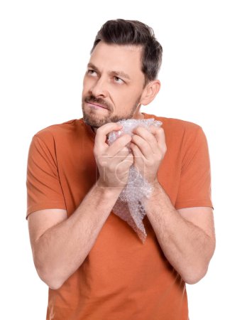 Photo for Man popping bubble wrap on white background. Stress relief - Royalty Free Image