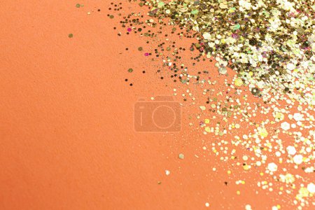Photo for Shiny bright glitter on pale coral background. Space for text - Royalty Free Image