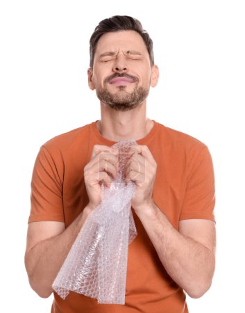 Photo for Man popping bubble wrap on white background. Stress relief - Royalty Free Image