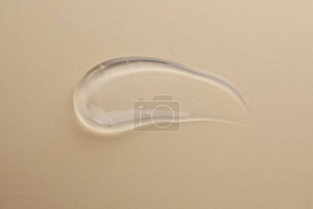 Photo for Sample of transparent gel on beige background, top view - Royalty Free Image