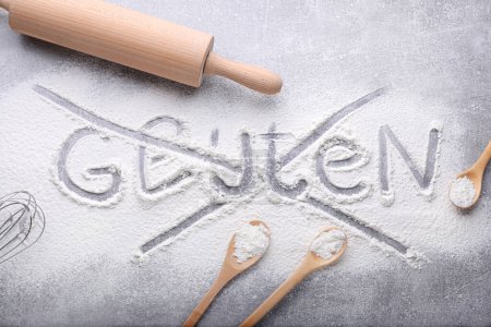 Photo for Crossed out word Gluten and different kitchen utensils on grey background, flat lay - Royalty Free Image