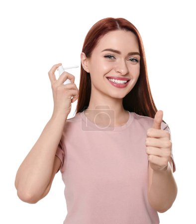 Photo for Woman using ear spray on white background - Royalty Free Image