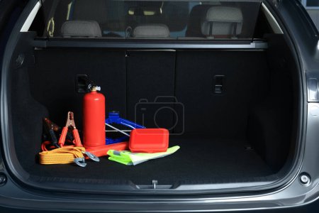 Set of car safety equipment in trunk, space for text