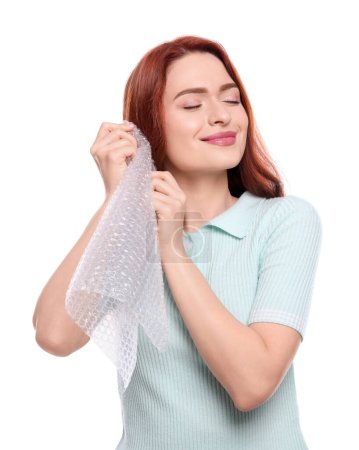 Photo for Woman popping bubble wrap on white background. Stress relief - Royalty Free Image