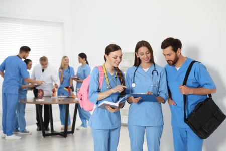 Photo for Medical students wearing uniforms in university hallway - Royalty Free Image