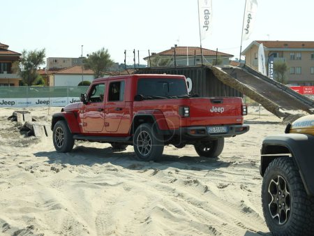 Photo for SENIGALLIA, ITALY - JULY 22, 2022: Jeep test drive on sand outdoors. Car presentation - Royalty Free Image