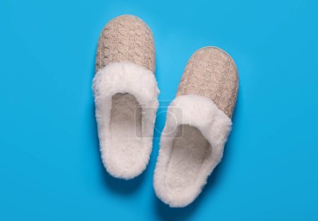 Photo for Pair of beautiful soft slippers on light blue background, top view - Royalty Free Image