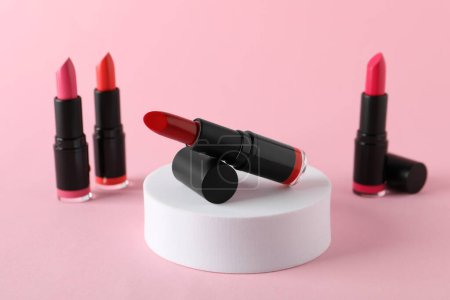 Photo for Different beautiful glossy lipsticks on pink background - Royalty Free Image