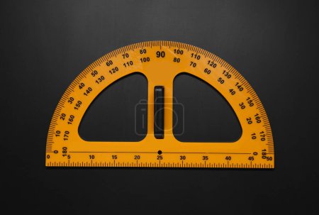 Photo for Yellow school protractor on blackboard, top view - Royalty Free Image