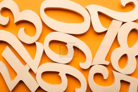 Photo for Wooden numbers on orange background, flat lay - Royalty Free Image