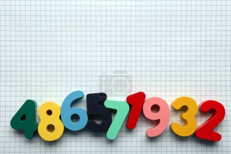 Photo for Colorful numbers on sheet of grid paper, flat lay. Space for text - Royalty Free Image