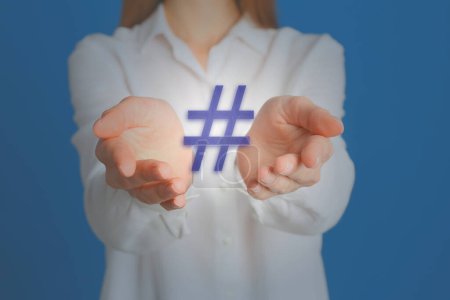 Photo for Hashtag concept. Woman holding sign on light blue background, closeup - Royalty Free Image