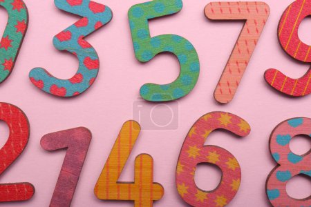 Photo for Colorful wooden numbers on pink background, flat lay - Royalty Free Image