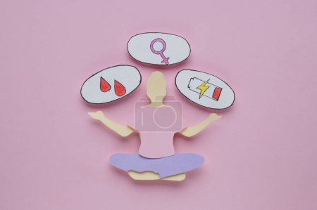 Foto de Woman`s health. Paper female figure and different stickers on pale pink background, flat lay - Imagen libre de derechos