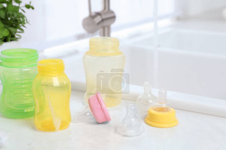 Photo for Baby bottles and nipples after washing on white countertop in kitchen - Royalty Free Image